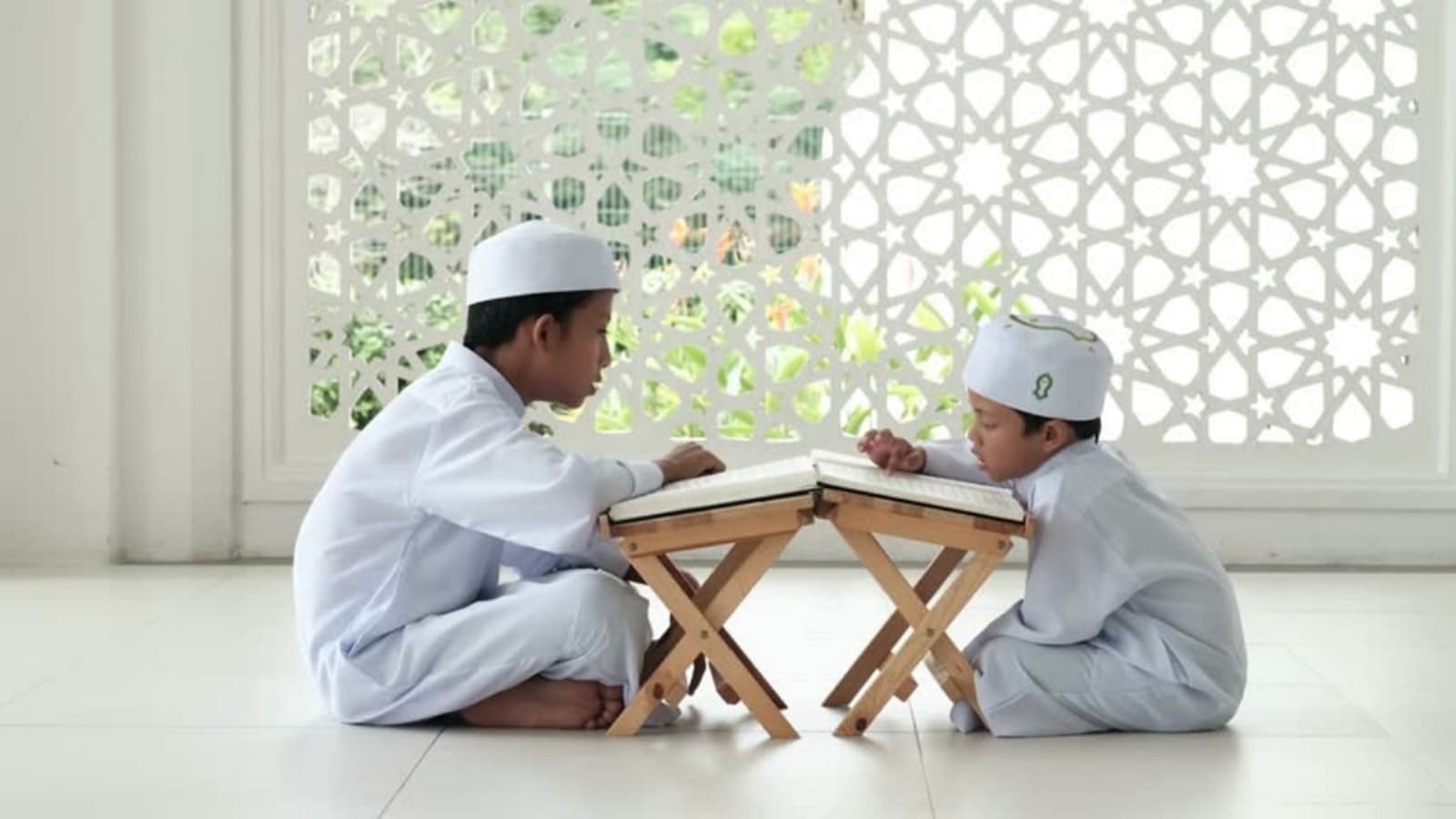 Two young students memorizing the Quran side by side